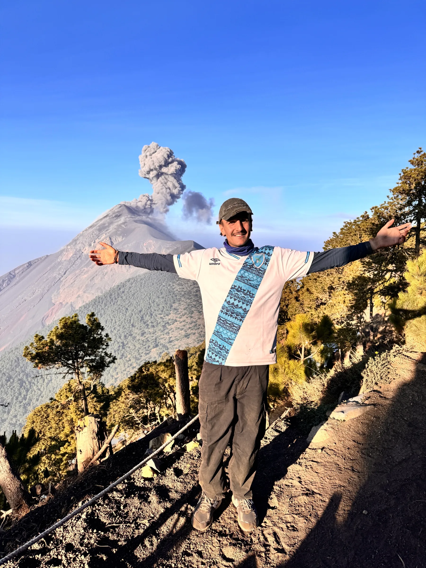 Wil Massara on a volcano in Guatemala, arms out
