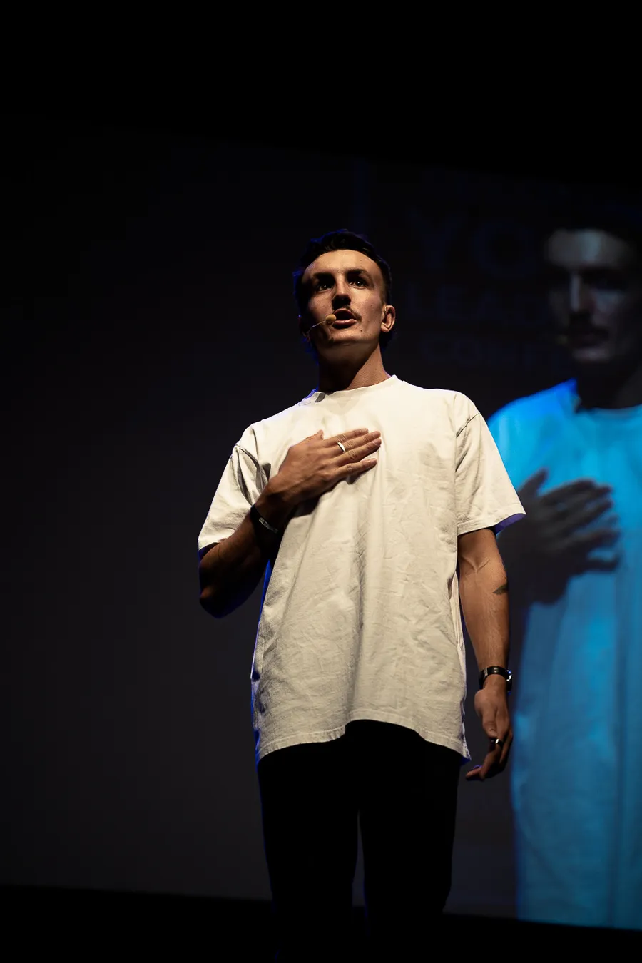 Wil Massara on stage, hand on heart